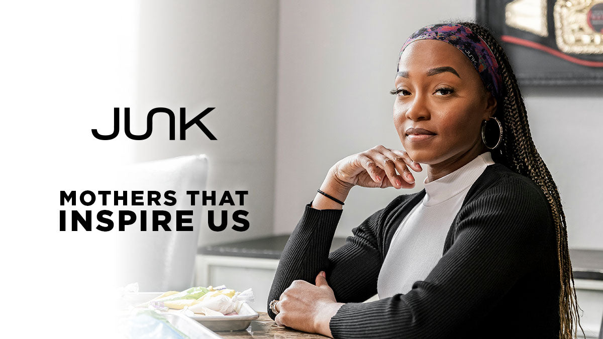 A chic black woman wearing a junk headband and gold earrings looks at the camera next to her cookie table with text overlay, “JUNK Mothers that inspire us” 