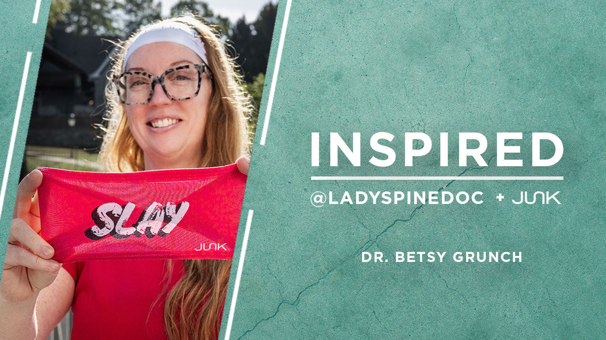 Dr Grunch holds up a headband that says slay, the text overlay says “Inspired: Dr. Besty Grunch @ladyspinedoc” 
