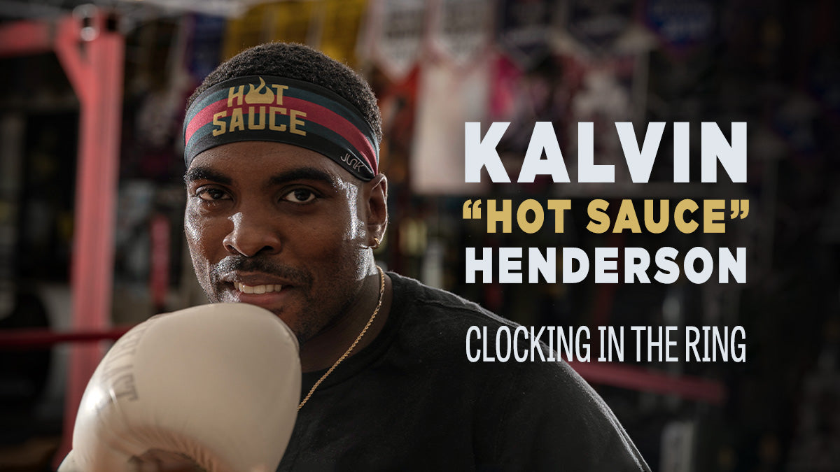 Image reads "Kalvin 'hot sauce' Henderson: Clocking in the ring" and shows an image of Kalvin, a black man, wearing white boxing gloves and JUNK Hot Sauce headband. There are posters on the wall in the background.