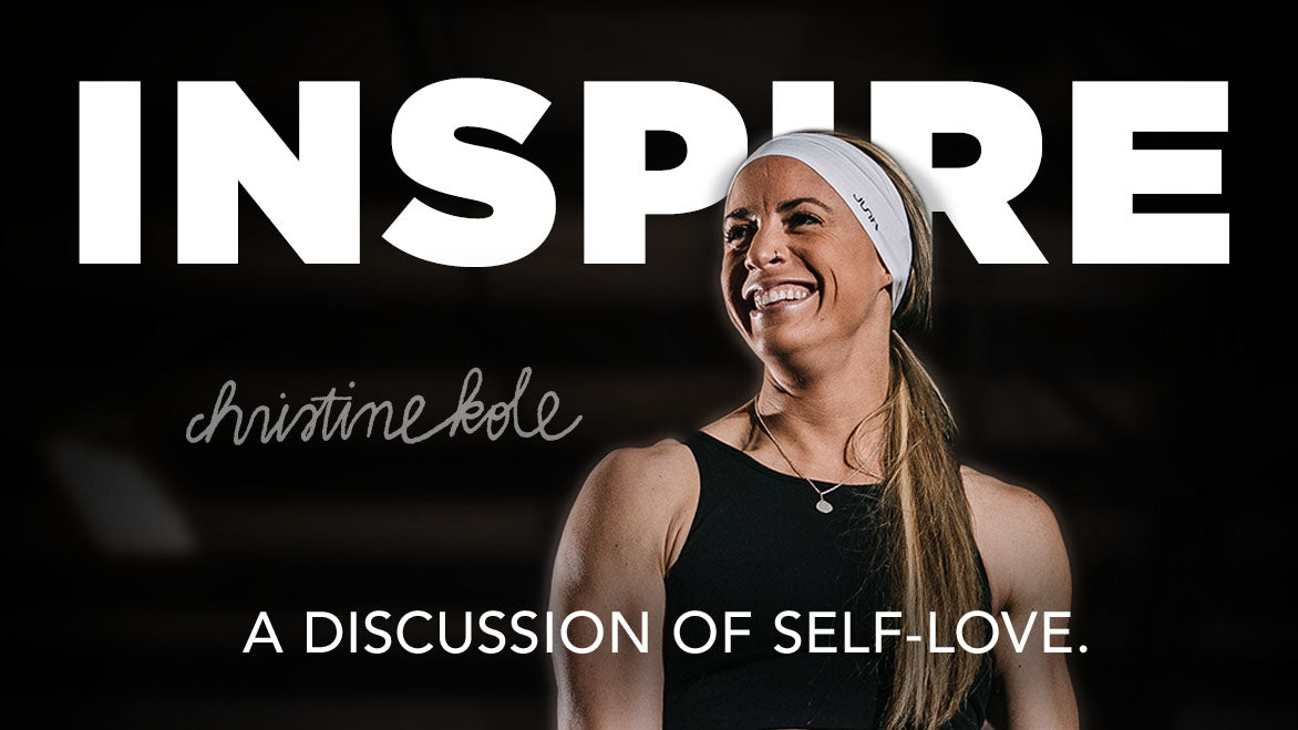 Christina Kole looks off the left of the image smiling. She has on a black athletic tank top with a silver necklace. Her signature is on the overlay of the screen that also reads “INSPIRE: A discussion of self love” 
