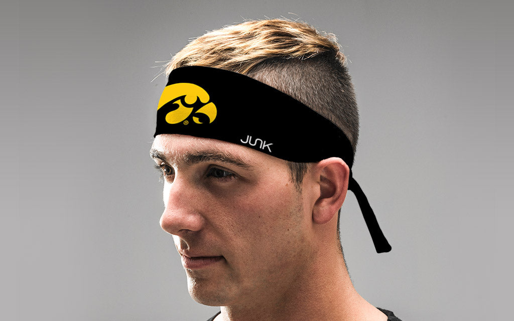 black headband with University of Iowa tiger hawk logo in gold on male
