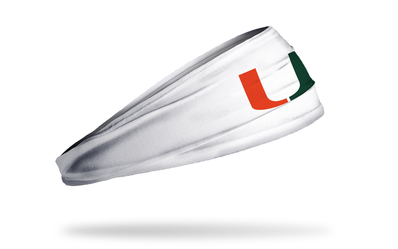 white headband with University of Miami U logo in orange and green