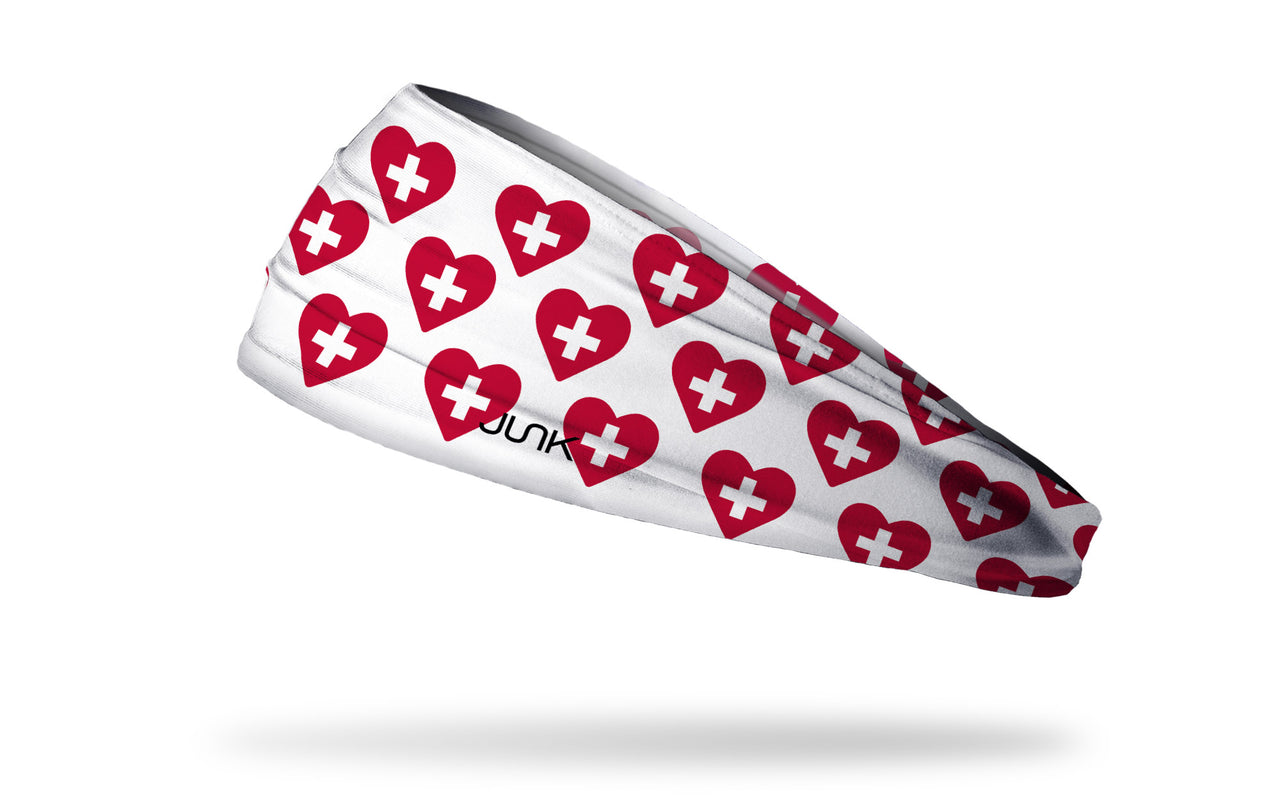 white medical themed headband with white positive symbol inside red heart pattern