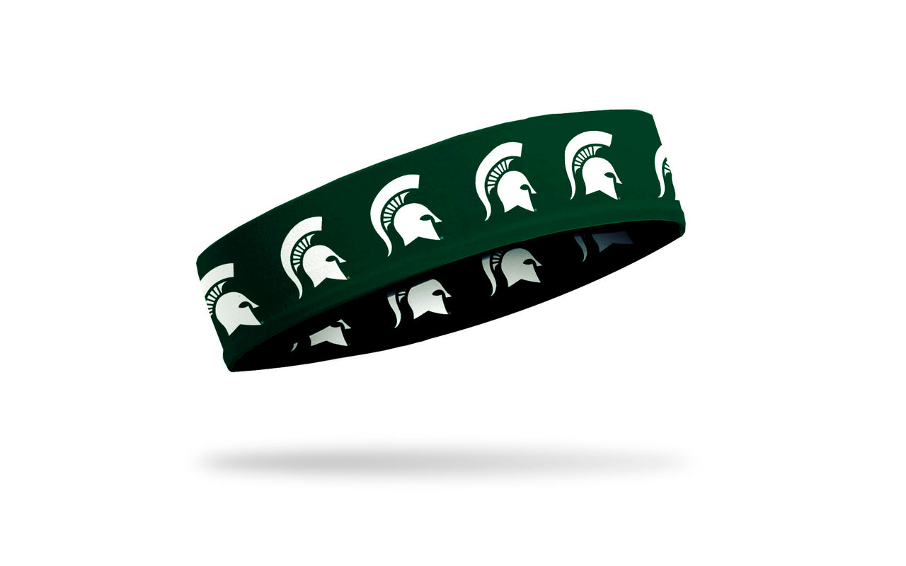 green headband with Michigan State University spartan logo repeating in white
