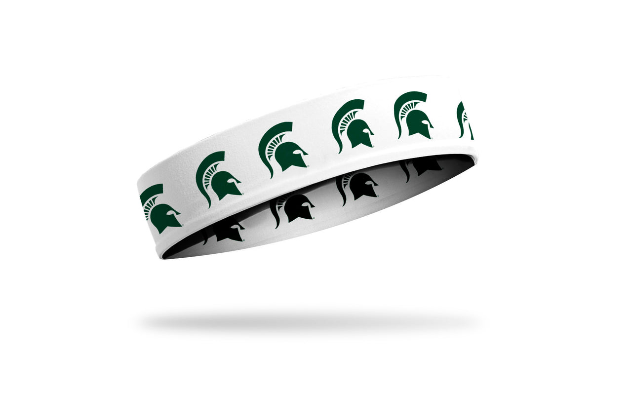 white headband with Michigan State University spartan logo repeating in green