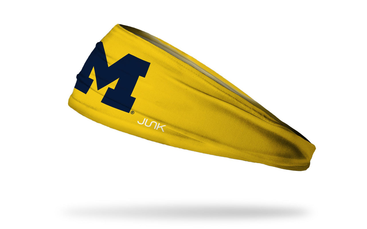 gold headband with University of Michigan M logo in navy