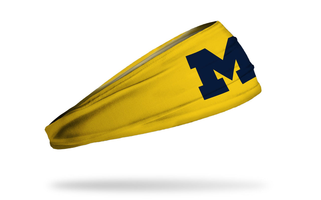 gold headband with University of Michigan M logo in navy