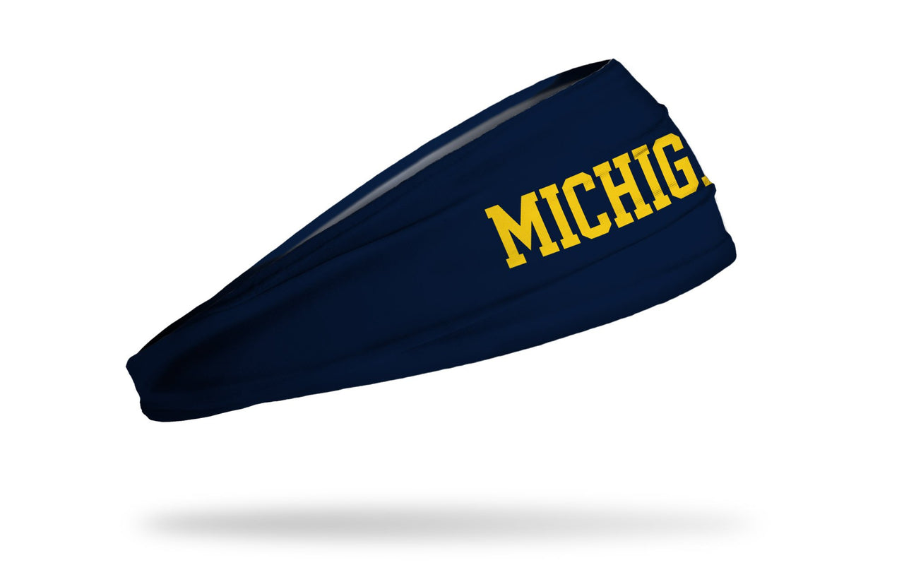 navy headband with University of Michigan Michigan wordmark logo in gold