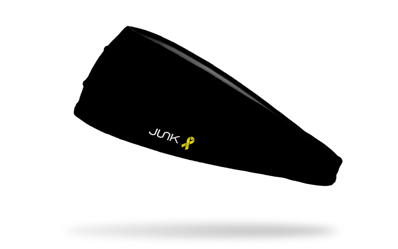 left side view of all black big bang lite headband with yellow ribbon to right of JUNK logo