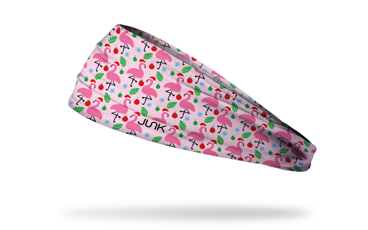 light pink winter christmas themed headband with repeating pattern of flamingos in santa hats ornaments and snowflakes