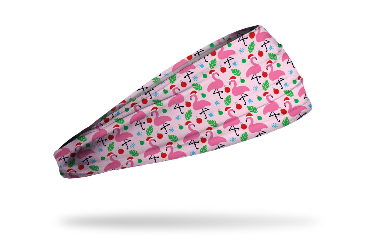 light pink winter christmas themed headband with repeating pattern of flamingos in santa hats ornaments and snowflakes